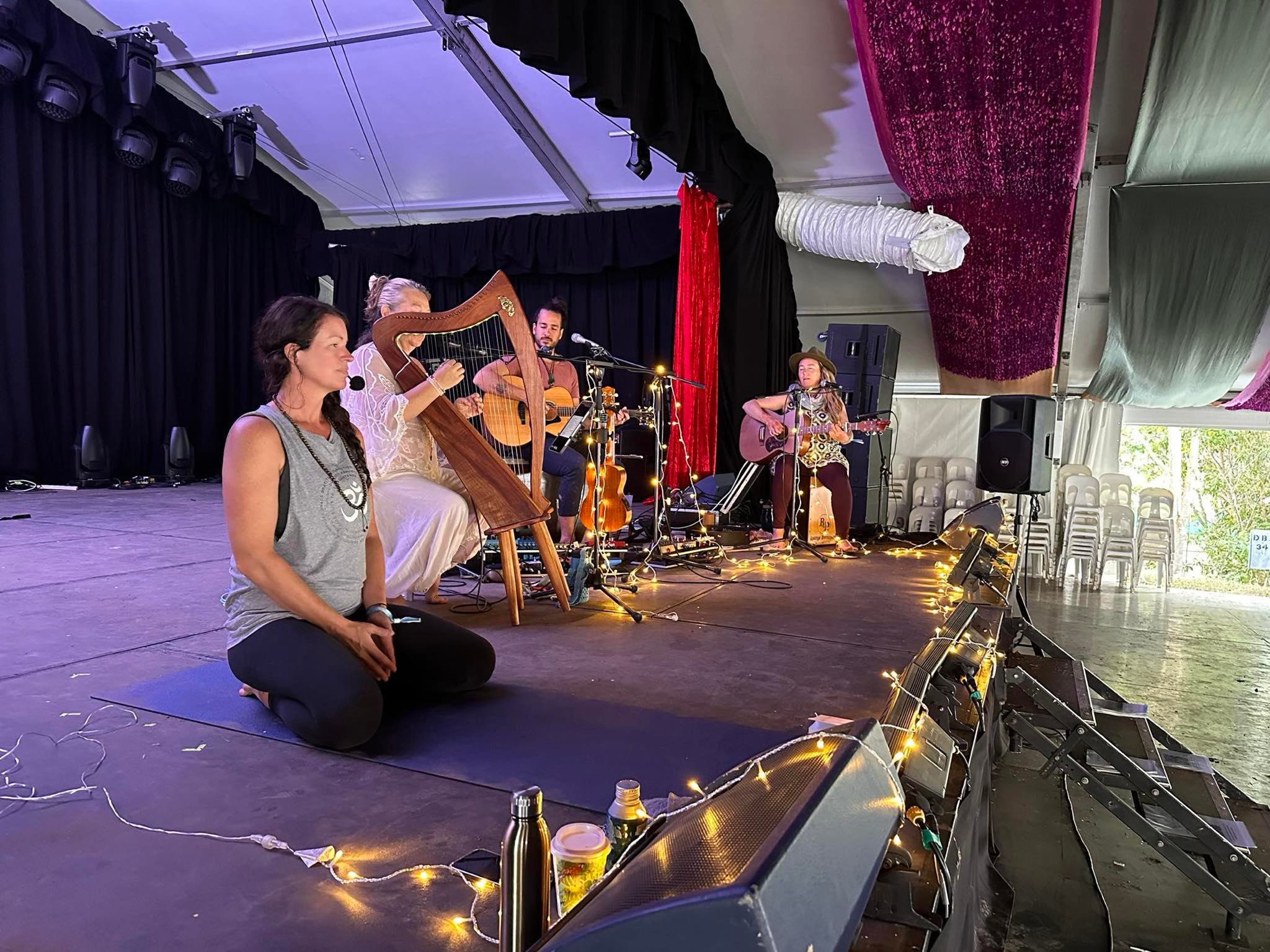 Musicians and a Yoga Teacher on stage at Woodford Folk Festival